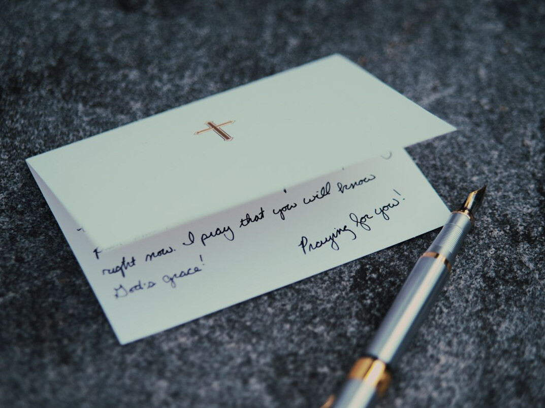 Handwritten notes and a pen on a desk